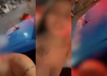 Mulher grava vídeo enquanto passeia em viatura da PM com parte do corpo pendurado em janela