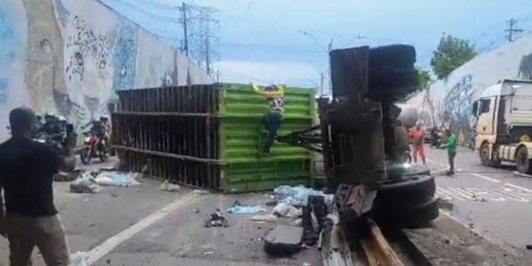 Motorista foge após tombar carreta com entulhos na Avenida das Flores; vídeo